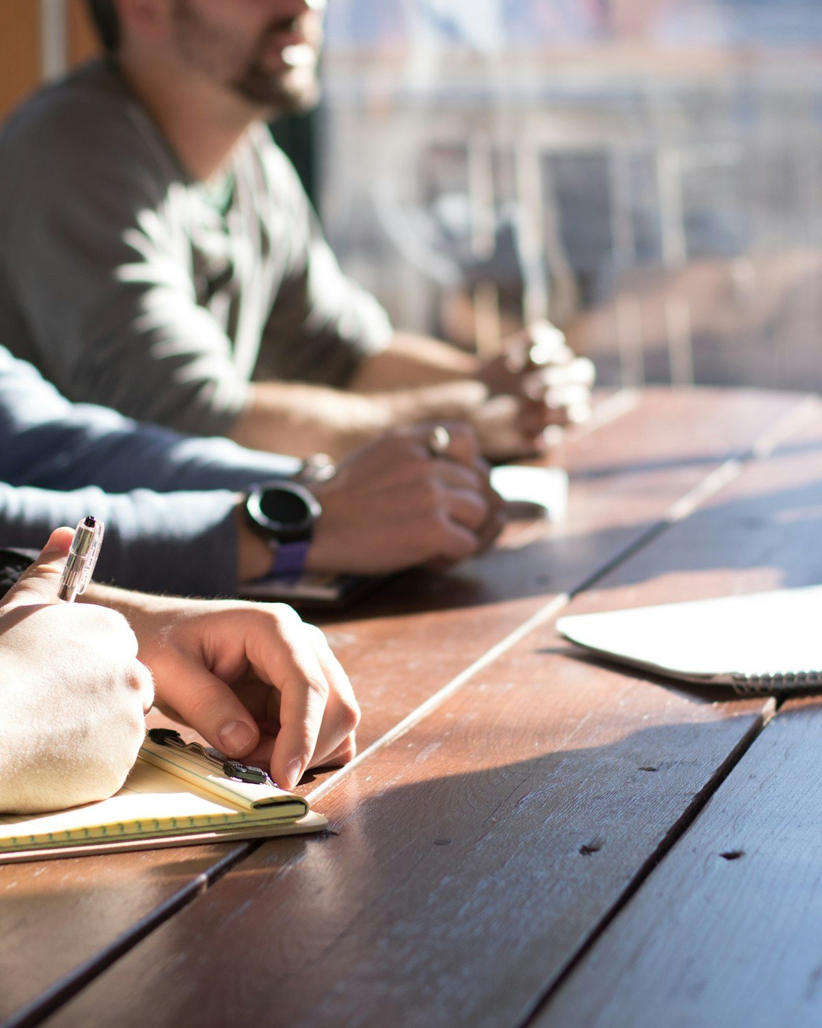 Four people working around a wooden table